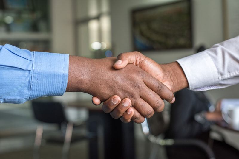 Shaking hands after agreeing on the key elements of a residential lease agreement