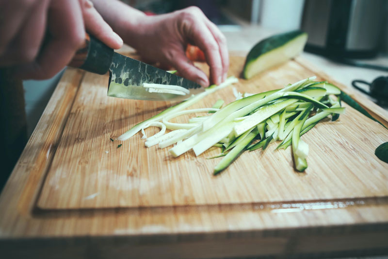 a person cutting veggies